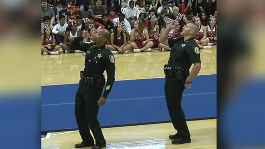 cops-dance-in-front-of-a-gym-full-of-high-schoolers