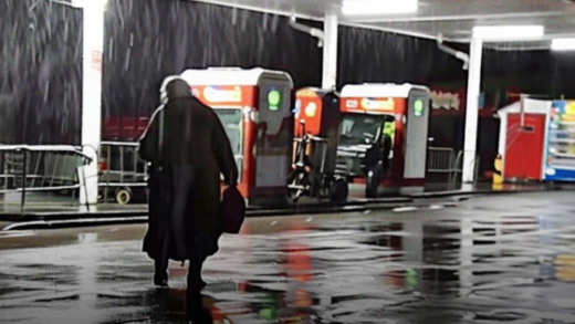 dirty-elderly-lady-runs-into-a-gas-station-on-rainy-night,-screaming-for-help